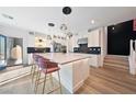A modern kitchen featuring a large island with seating, pendant lighting, and stainless steel appliances at 2722 Marchetti Pl, Henderson, NV 89044