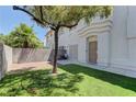 Private backyard with a mature shade tree and green lawn, ideal for outdoor living and relaxation at 278 Star Cluster Cir, Las Vegas, NV 89145