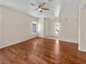 Spacious room with hardwood flooring, ceiling fan, and ample natural light from the windows at 3053 Monroe Park Rd, Henderson, NV 89052