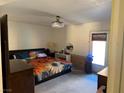 Spacious bedroom featuring a ceiling fan, large bed and natural light from the window at 3447 One Nation Ave, Las Vegas, NV 89121