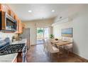 Eat-in kitchen with stainless steel appliances, tile flooring, and sliding door access to the outside at 3640 Shanagolden St, Las Vegas, NV 89129