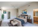 Spacious main bedroom with plush bedding, ensuite bathroom, and walk-in closet for ample storage at 3640 Shanagolden St, Las Vegas, NV 89129