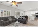 Open concept living room featuring gray sofas, ceiling fan, and tile floors at 4498 Lantern Point Ave, North Las Vegas, NV 89084