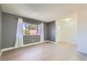 Light-filled living room with large window, fresh paint, and new floors at 4683 Monterey Cir # 4, Las Vegas, NV 89169