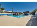 Community pool featuring a large pool, sun loungers, shade and palm trees at 4683 Monterey Cir # 4, Las Vegas, NV 89169
