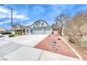 Exterior elevation showcasing the home's architecture, driveway, and landscaping at 511 Beaconwood St, Henderson, NV 89052