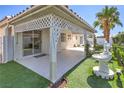 Charming backyard with covered patio, lush greenery, and a serene fountain, perfect for outdoor living at 5425 Thomaston Ct, Las Vegas, NV 89122