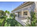Inviting backyard with covered patio, manicured lawn, and elegant fountain, perfect for relaxation at 5425 Thomaston Ct, Las Vegas, NV 89122