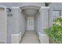 Close up view of a covered front entryway with security door and house number at 5820 Royal Castle Ln, Las Vegas, NV 89130