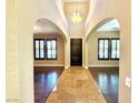 Inviting foyer with high ceilings, arched doorways and elegant tile flooring at 585 Via Alhambra, Las Vegas, NV 89123
