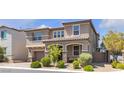 Charming two-story home featuring a two-car garage, landscaped front yard, and welcoming covered porch at 6370 Ava Ridge Ave, Las Vegas, NV 89141