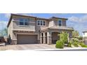 Beautiful two-story home with a two-car garage, landscaped front yard and covered porch with stone accents at 6370 Ava Ridge Ave, Las Vegas, NV 89141