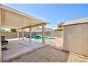 Backyard patio featuring a refreshing pool with hot tub and shed, great for outdoor storage at 700 Red Bark Ln, Henderson, NV 89011