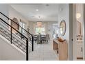Elegant dining room features stylish chandelier, modern furniture, and bright natural light at 734 Glowing Horizon St, Henderson, NV 89052