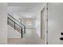 Bright entryway with staircase, light tile flooring, and an open floor plan at 734 Glowing Horizon St, Henderson, NV 89052