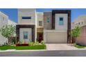 Contemporary two-story home boasts clean lines, neutral colors, and attached two-car garage at 734 Glowing Horizon St, Henderson, NV 89052