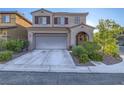 Two-story home with desert landscaping, an attached two-car garage, and a covered front porch at 7605 Lake Fork Peak St, Las Vegas, NV 89166