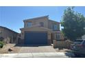 Two-story home featuring a paver driveway, a two-car garage and a modern design at 7636 Bandon Cliffs St, North Las Vegas, NV 89084