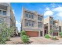 Contemporary three-story home featuring a garage and low-maintenance landscaping at 8072 Haywood Estate Ave, Las Vegas, NV 89113