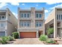 Contemporary three-story home featuring a garage and low-maintenance landscaping at 8072 Haywood Estate Ave, Las Vegas, NV 89113