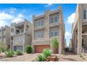 Contemporary three-story home featuring a garage and low-maintenance landscaping at 8072 Haywood Estate Ave, Las Vegas, NV 89113