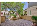 Private courtyard with brick-paved flooring and lush landscaping at 9814 Gifthouse St, Las Vegas, NV 89178