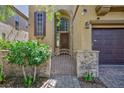 Charming home exterior featuring a decorative iron gate and brick accents at 9814 Gifthouse St, Las Vegas, NV 89178