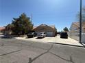 Street view of a single story home with two car garage and desert landscaping at , Las Vegas, NV 89145