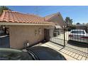 View of side yard with metal fence and tile roof at , Las Vegas, NV 89145