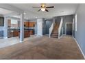 Open concept living space showcasing a seamless flow between the living area, kitchen, and staircase at 1012 Water Cove St, Henderson, NV 89011