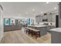This open kitchen boasts a large center island, stainless steel appliances, and gray cabinetry, perfect for modern living at 10904 Ellis Pointe Ave, Las Vegas, NV 89166