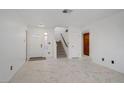 Bright living room with marble floors, open layout, with stairs to second floor at 117 Lotus Blossom Ct, Las Vegas, NV 89145