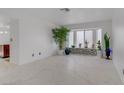 Bright living room with marble floors, a bay window with decorative tile, and an open layout at 117 Lotus Blossom Ct, Las Vegas, NV 89145