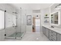 Gorgeous bathroom features a large shower, vanity with storage, and lots of natural light at 1405 Bugle Boy Dr, Henderson, NV 89014
