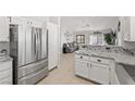 Open concept kitchen with granite countertops flows into a living space at 1405 Bugle Boy Dr, Henderson, NV 89014