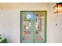 Exterior shot of the front door with green trim and ambient outdoor lighting at 1905 Plaza Del Padre, Las Vegas, NV 89102