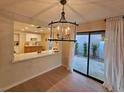 Well-lit dining area features a modern chandelier and sliding glass doors at 1905 Plaza Del Padre, Las Vegas, NV 89102