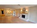 Spacious living room features a cozy fireplace and modern light wood flooring at 1905 Plaza Del Padre, Las Vegas, NV 89102