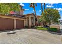 Attractive home showcasing a manicured lawn, a two-car garage, and a charming covered entry at 2042 Maple Springs St, Henderson, NV 89002