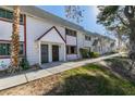 Two-story townhome with white walls, red trim, desert landscaping and a sidewalk leading to the front doors at 225 Pecos Way, Las Vegas, NV 89121