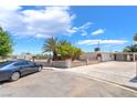 Single-story home boasts a large driveway, desert landscaping, and an attached carport for convenient parking at 2749 Del Mar Pl, Las Vegas, NV 89169