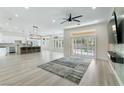 Bright, open-concept living room featuring modern lighting, flooring, and a sliding glass door at 2755 Darby Falls Dr, Las Vegas, NV 89134