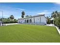 Charming single-Gathering home featuring a lush front lawn, a three-car garage, and a serene curb appeal at 324 Park Way, Las Vegas, NV 89106