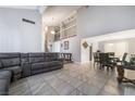 Spacious living room showcasing high ceilings, tile flooring, and an adjacent dining area perfect for entertaining at 327 Fuente Dr, Henderson, NV 89014