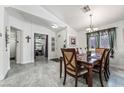 Bright dining area with tile floors, pendant lighting, and a view into the adjacent living spaces at 3495 Eagle Bend St, Las Vegas, NV 89122