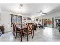 Open-concept living and dining area with tile flooring, vaulted ceilings, and access to the backyard pool at 3495 Eagle Bend St, Las Vegas, NV 89122