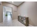 Inviting foyer featuring tile floors, a cabinet for storage, and an open view to the rest of the home at 4523 Herbert River Ave, Las Vegas, NV 89141