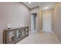 Bright entry foyer boasts tile flooring, storage cabinet, and neutral paint scheme at 4523 Herbert River Ave, Las Vegas, NV 89141