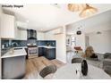 Well-lit kitchen boasts two-tone cabinets, stainless steel appliances, and an eat-in area at 5004 Celebrity Cir, Las Vegas, NV 89119
