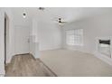 Bright living room featuring neutral carpeting and wood-look flooring at 5112 Harvest Time St # 201, Las Vegas, NV 89130